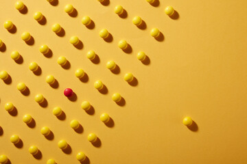 Red candy on a pile of yellow ones