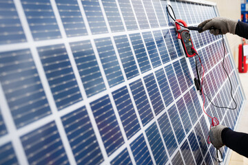 Worker used a meter for checking the readiness of the solar panel to confirming function normally before installation. Solar panels installation process.