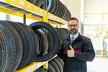 Portrait of senior man mechanic in tires shop services. Good service and professional tires shop concept.