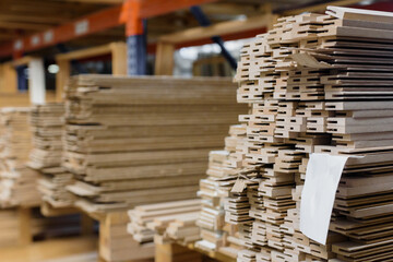 Fototapeta premium Warehouse with stacked wooden timber on racks for construction and repair