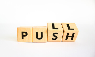 Pull or push symbol. Turned wooden cubes and changed the word 'push' to 'pull'. Beautiful white background, copy space. Business and pull or push concept.