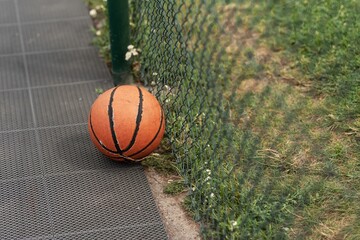 old basketball ball isolated on court