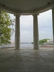 View from the pavilion "Under the flag" on the columns and the river in the park on the Elagin Island of St. Petersburg.