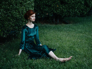 woman sitting on green grass in the garden nature summer carnival