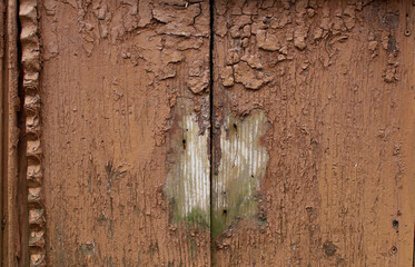 Part of an old and abandoned wooden door. Retro background. Closeup. 