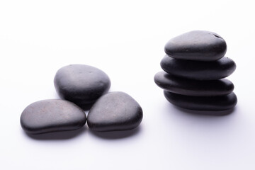Balanced pile of spa stones isolated on white background