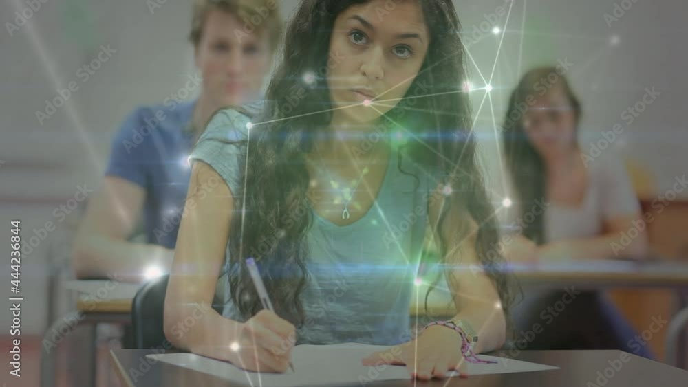 Poster animation of glowing network of connections moving over students writing in classroom