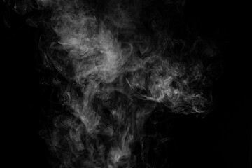 Vapour rising against dark background landscape