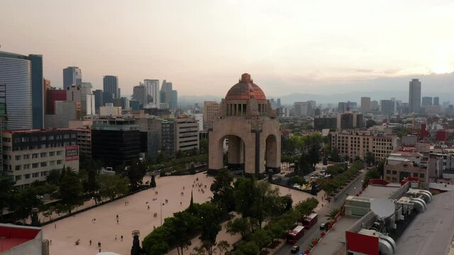 Aerial view of famous Monument to Revolution on Plaza de la Republica. Forward fly to historic landmark. Cityscape in background. Mexico City, Mexico.