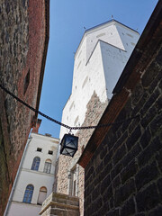 A narrow passage with a lantern suspended on chains, between the stone walls of the Vyborg Castle...