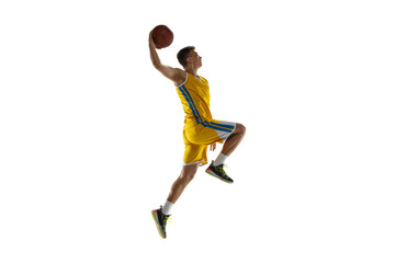 Side view. One young man, basketball player with a ball training isolated on white studio background. Advertising concept. Fit Caucasian athlete jumping with ball.