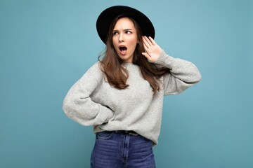 Closeup photo of beautiful attractive shocked amazed surprised young woman with open mouth wearing...