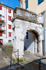 Fototapeta na wymiar Ancient roman city entrance gate, in the old city center of Trieste (Northern Italy, Friuli Region).