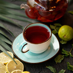 Morning cup of Black tea with lemon and mint. Close up shot. Soft focus. Square format.