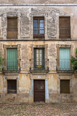 View of the main facade of an old building in ruins, with numeral 1 on the door, in the historic center of Cuidad Rodrigo downtown