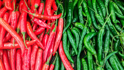 red and green chili peppers in traditional market