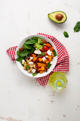 Overhead view of  winter pumpkin salad with avocado healthy food