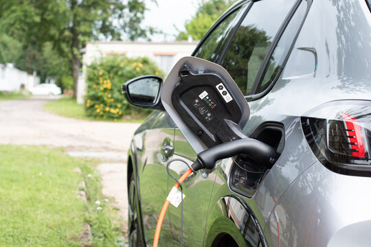 E Electric e-car on charge charging from home in a rural setting