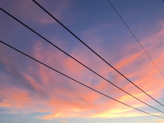 sunset in the city with electrical cables 