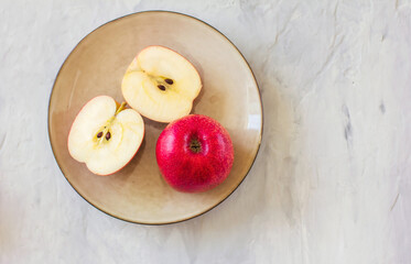 Apples and cups with plates on a grey background. Concept of healthy nutrition and vitamins. Flat lay with copy space. Horizontal orientation