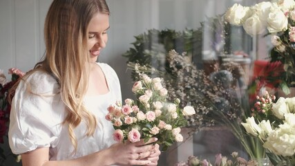 Young woman appreciating flower bouquet fragrance