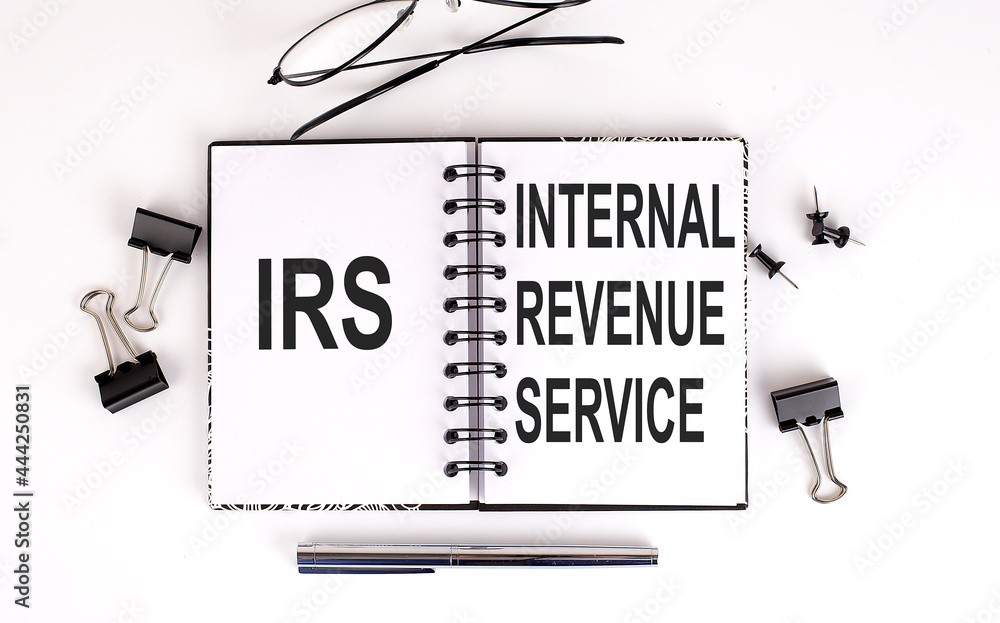 Poster notebook with text irs on a table,business concept