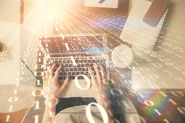 Double exposure of woman hands working on computer and data theme hologram drawing. Top View. Technology concept.