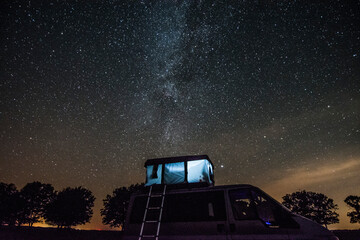 Camper van vith roof tent during night in Bebrza national park.