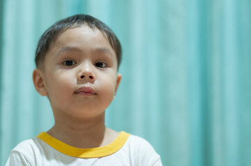 Little cracked cut on boy's lip. Child boy with herpes sore on the lip, mouth