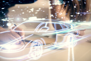 Double exposure of automobile icon hologram and woman holding and using a mobile device. Technology concept.