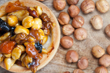 dough tartlet nuts and dried fruits covered with caramel