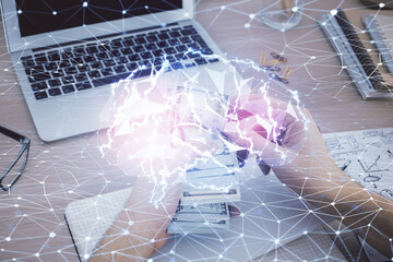 Multi exposure of brain drawing hologram and us dollars bills and man hands. Ai invest concept