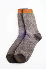 Pair of warm grey socks on white background