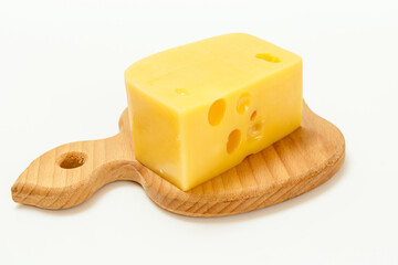 Slice of cheese on wooden cutting board on white background