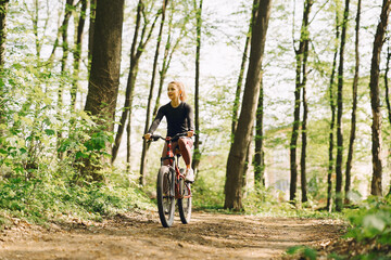 Woman riding a mountain bike in the forest