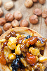 dough tartlet nuts and dried fruits covered with caramel