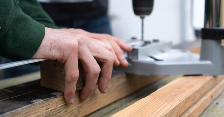 Carpenter drilling a hole
