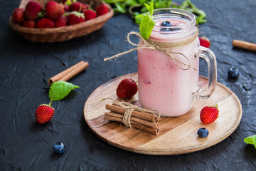 Healthy smoothie of fresh summer berries. Creative atmospheric decoration