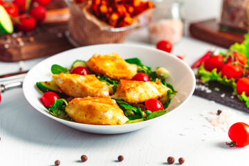 Camembert. Fried camembert cheese with batat fries. Cheese with salad with tomatoes. Fresh food