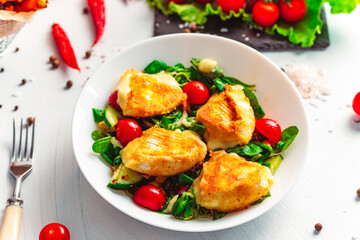 Camembert. Fried camembert cheese with batat fries. Cheese with salad with tomatoes. Fresh food