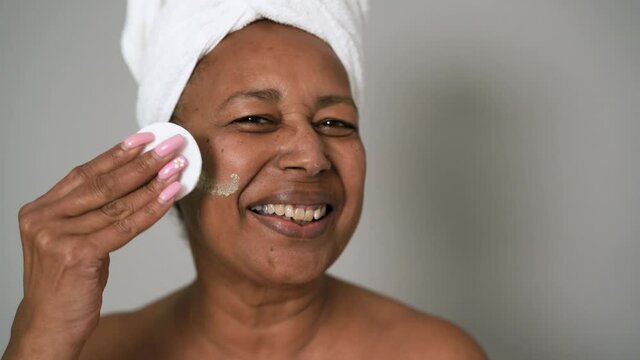 Happy African Senior Woman Having Skin Care Spa Day - People Wellness Lifestyle Concept 