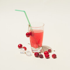 Summer composition  on pastel background. cold drink made  with fresh organic red fruit and ice cubes. refreshment concept.
