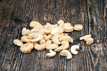 cashew nuts on an old wooden table, close up