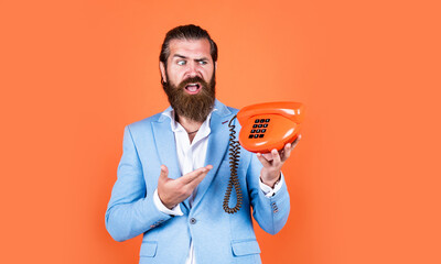 handsome caucasian businessman with trendy hairstyle in jacket speak on vintage phone, call