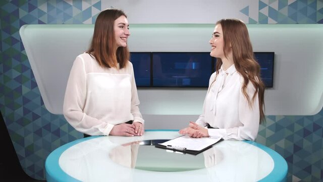 Female presenter interviewing a famous woman at tv studio