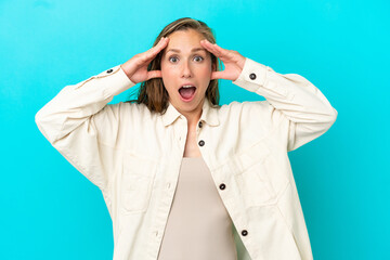 Young caucasian woman isolated on blue background with surprise expression