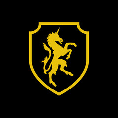 Logo heráldica con silueta de caballo unicornio medieval de pie en escudo de color amarillo y fondo negro © teracreonte