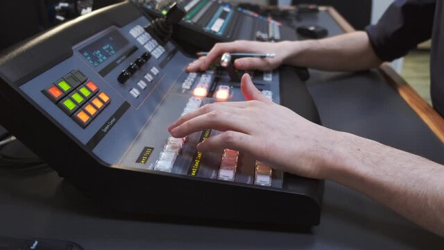 Close up of sound engineer hands recording music