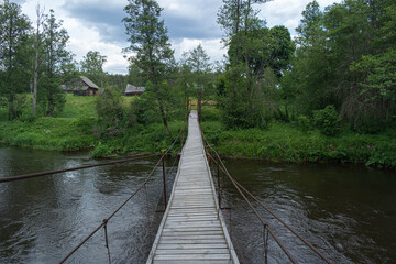 Fototapeta na wymiar Oldest suspension bridge over the river. Nord Europe.