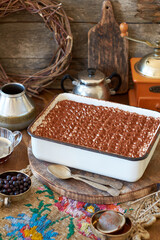 Homemade tiramisu. Wooden background. Side view. Cake and coffee.